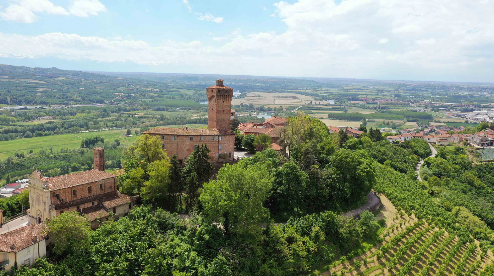 Hilltop castle above vineyards in Piedmont, Italy